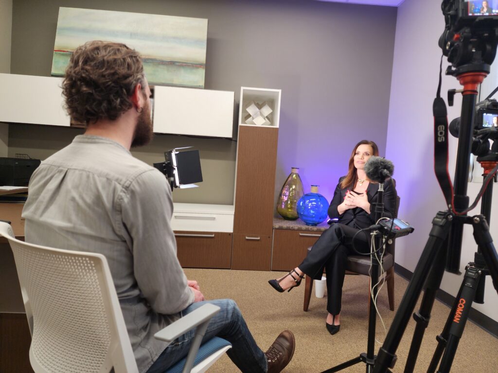 one person directing a video interview for a client